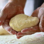 bakers hands knead dough