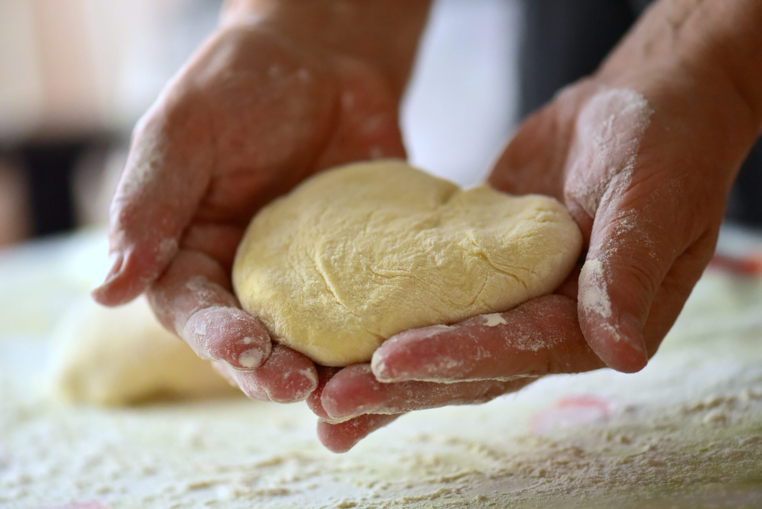 bakers hands knead dough